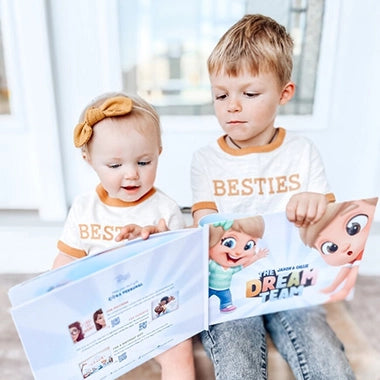 Two toddlers reading their Besties book together