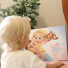 Girl looking at a book which is customized for her dad and her from Hooray Heroes.