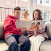 A young family reading a personalized mom book for Mother's Day.