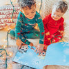 Kids read through their new DIY Xmas book for siblings and go on magical Christmas adventures together.