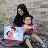 A mother and her son with her Mother's Day gift, a personalized book mommies.