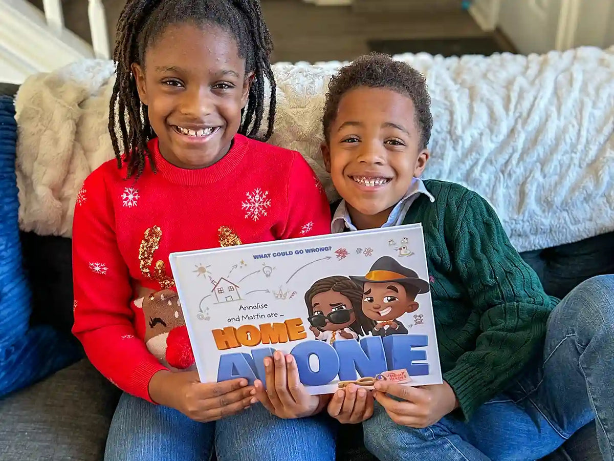 Two siblings holding their new personalized Home Alone book.