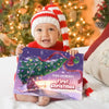 Smiling baby wearing a Christmas hat holding a personalized holiday book titled “Grace and Mama’s First Christmas 2025."