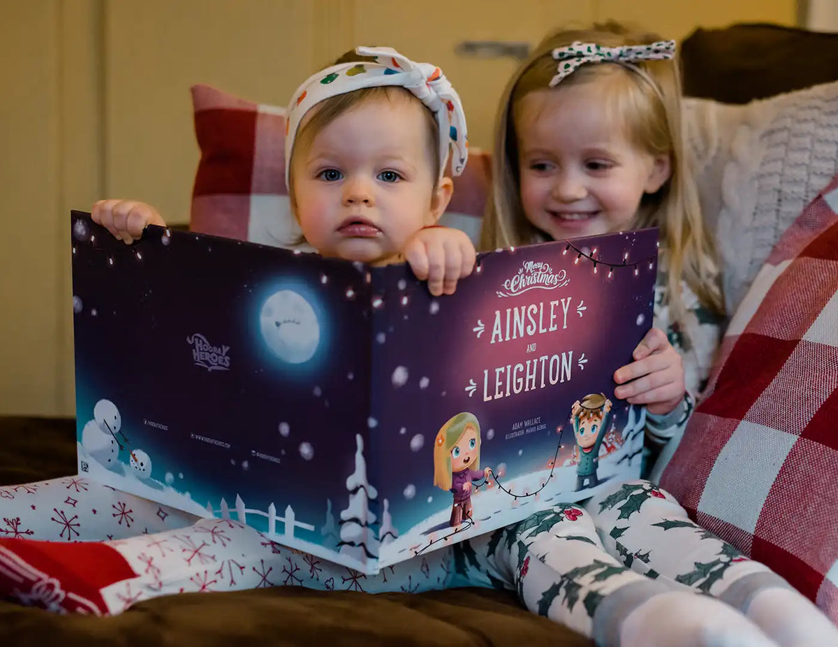 Siblings are having fun browsing through their fun personalized festive book about Christmas.