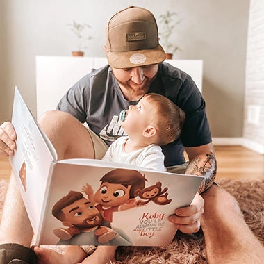 Cute bonding moment with father and his son when reading personalized book
